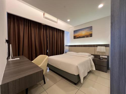 a hotel room with a bed and a desk at QUINCE HOME GRAND ION DELEMEN GENTING HIGHLANDs in Genting Highlands
