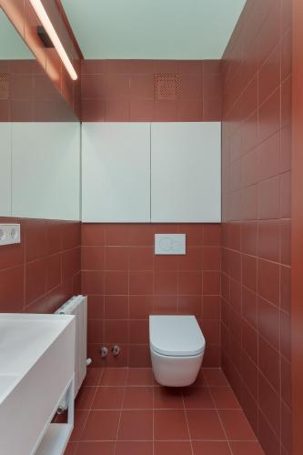 a red bathroom with a toilet and a sink at Majordoms Estada Historica in Banyoles
