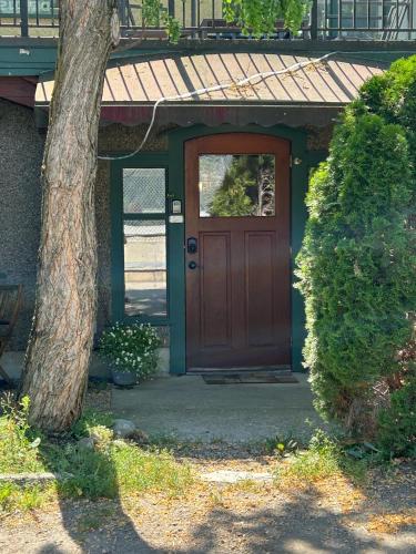 a door of a house with a tree next to it at Mistiso's Place Vacation Rentals in Nelson