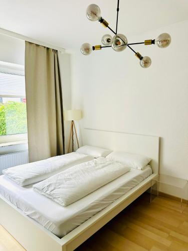 a bed in a white room with a window at FRIDA Hannover City Apartment&Privatzimmer in Hannover