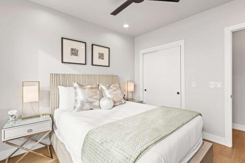 a white bedroom with a bed and a table at Luxury Lakeview Retreat A Jordanelle Gem in Hideout, Utah in Keetley