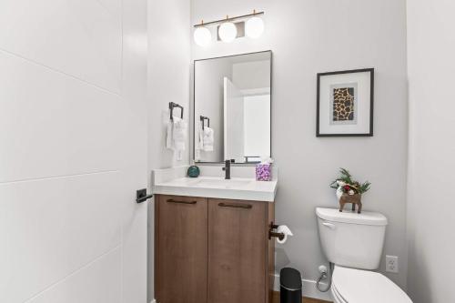 a bathroom with a toilet and a sink and a mirror at Luxury Lakeview Retreat A Jordanelle Gem in Hideout, Utah in Keetley