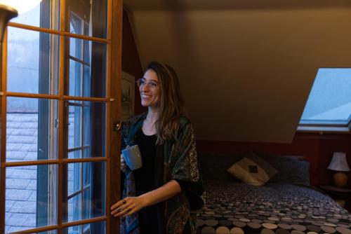 a woman standing in a room looking out the window at Mistiso's Place Vacation Rentals in Nelson
