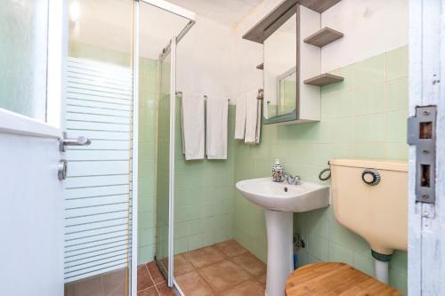 a bathroom with a sink and a shower at Casa da Praia 2 in Budens