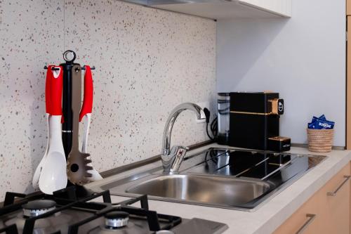 a kitchen counter with a sink and a stove at Casa Zia Lina in Modica
