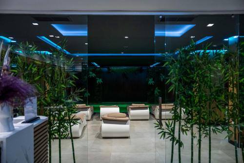 a lobby with a bunch of potted plants at Henry Resort & Spa in Golem