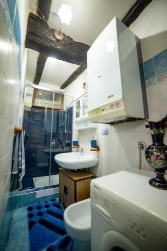 a bathroom with a sink and a toilet and a shower at To Be Home in Bomarzo