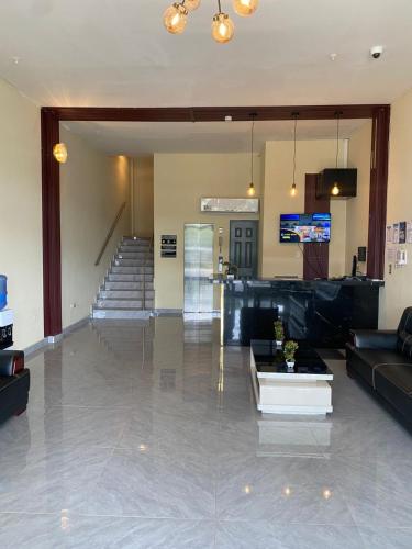 a living room with a couch and a table at Hotel Plaza Corotú-HPC in Santiago