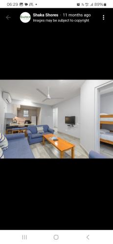 a living room with a couch and a table at Shaka Shores in Durban