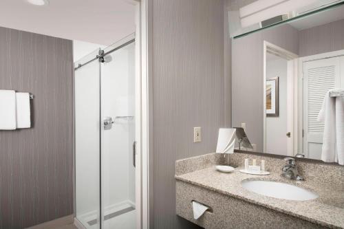 a bathroom with a sink and a shower at Courtyard by Marriott Portland Hillsboro in Hillsboro