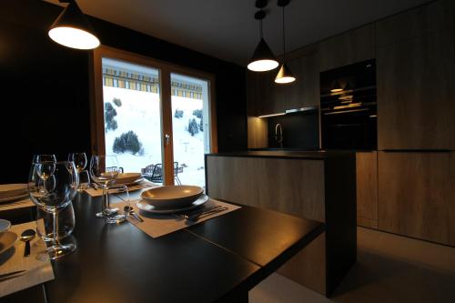 a dining room with a table with wine glasses at Appartement ski in-out 4-6 pers Les Crosets Porte du Soleil in Les Crosets