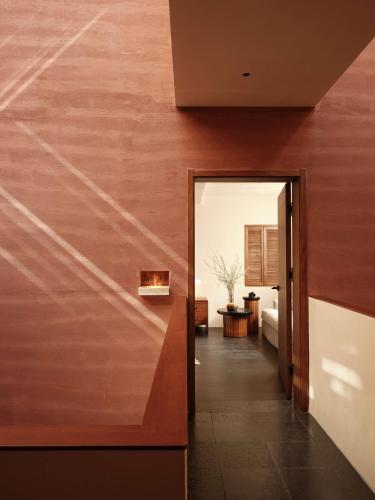 a hallway leading to a living room with wood walls at 大理空岛半山海景民宿 in Dali