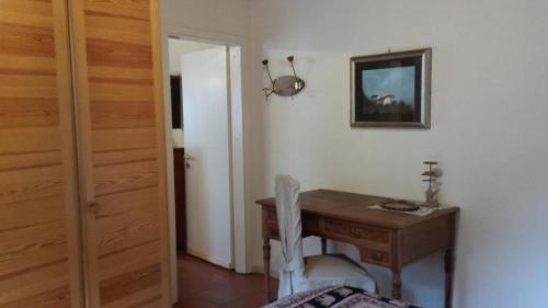 a room with a wooden desk and a table with a chair at Casa San Cristoforo Atelier in Maggia