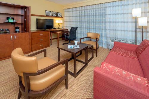 a living room with a couch and a table at Courtyard Winston-Salem Hanes Mall in Winston-Salem