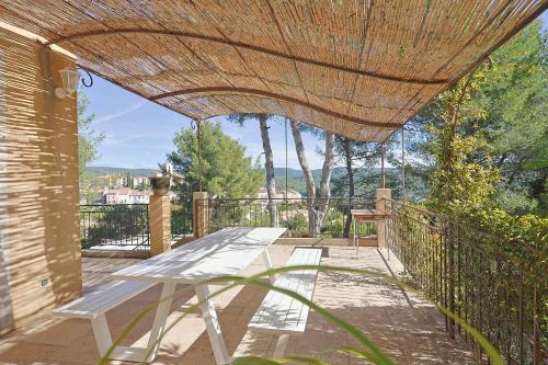 a picnic table on a patio with a roof at Vendange Tardive in Flayosc