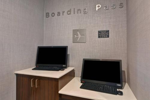 two laptop computers sitting on counters in a room at Courtyard by Marriott Long Island Islip/Courthouse Complex in Central Islip