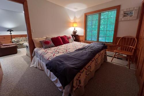 a bedroom with a bed and a window at Moose & Red Fox Retreat in Denmark