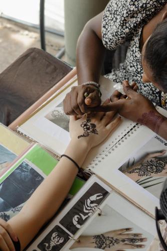 a group of people getting their hands painted on a persons arm at Armenian House by IIP in George Town