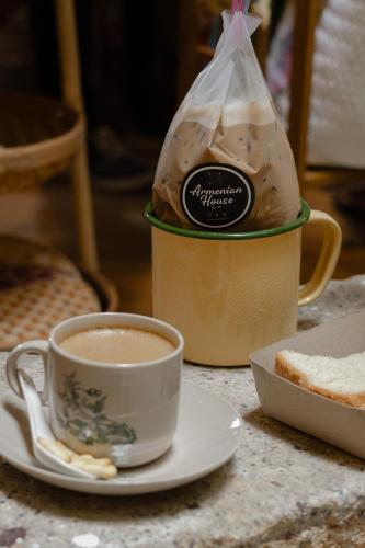 a cup of coffee and a bag of bread on a table at Armenian House by IIP in George Town