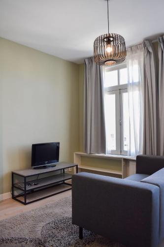 a living room with a couch and a tv at NEW Roof terrace apartment in Jordaan Area in Amsterdam
