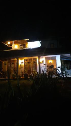 a house lit up at night with lights at Jithu homestay Mirissa in Mirissa