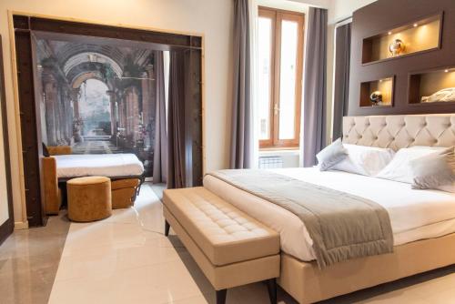 a bedroom with a large bed with a bench in it at Adelaide Suite Dreams in Rome