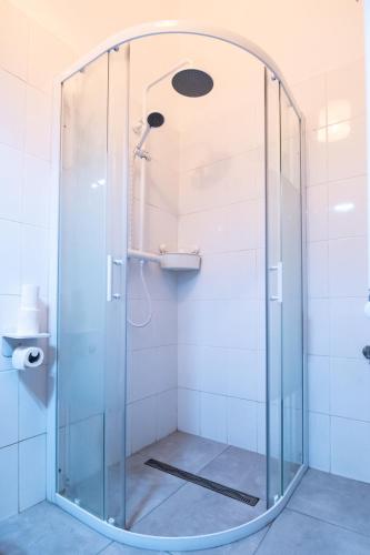 a shower with a glass door in a bathroom at Altius Studio 2 in Braşov
