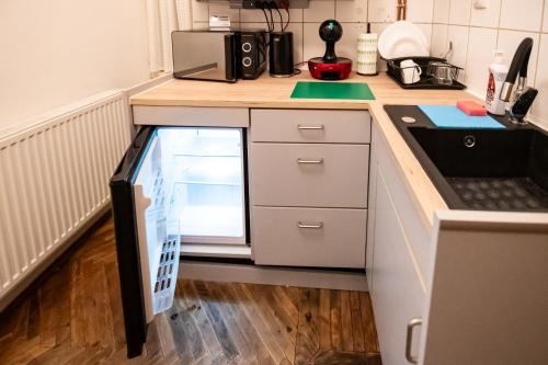 a kitchen with a counter with a refrigerator in it at Altius Studio 2 in Braşov