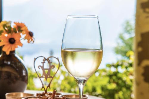 a glass of white wine sitting on a table at Hotel Victoria Glion in Montreux