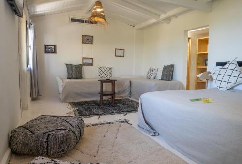 a bedroom with two beds and a couch in it at Dakhla Attitude in Dakhla
