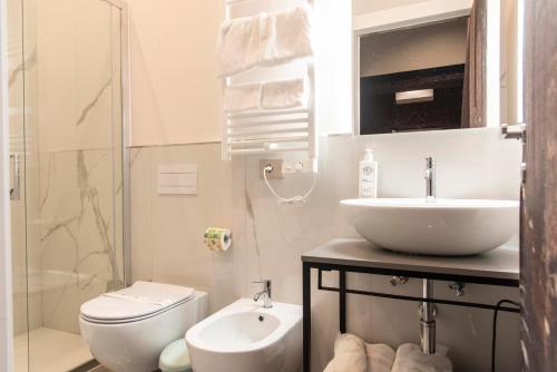 a bathroom with a sink and a toilet and a shower at Adelaide Suite Dreams in Rome