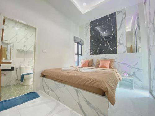 a bedroom with a bed with a glass wall at Hotel Royale in Jomtien Beach