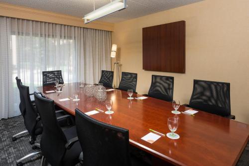 a conference room with a long wooden table and chairs at Courtyard Chicago Wood Dale / Itasca in Wood Dale