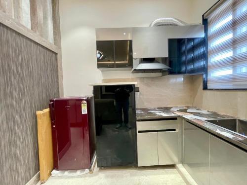a kitchen with a person standing in the middle at Marine Ganga Stays in Rishīkesh