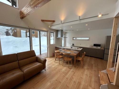 a living room with a couch and a table at Kokoro House Misorano in Hakuba