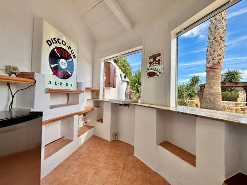 a kitchen with a counter and a window at Casa Mica in Albox