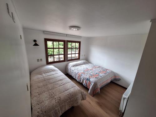 Ένα ή περισσότερα κρεβάτια σε δωμάτιο στο Cabañas y Hostel Praga