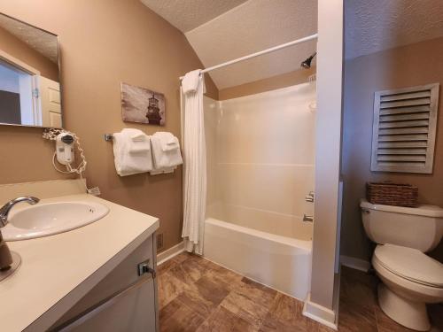 a bathroom with a sink and a toilet and a shower at North Shore Inn TC 308 in Traverse City