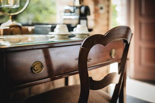 a wooden chair sitting in front of a counter at Residenza San Vito in Calamandrana
