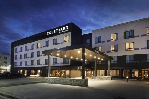 a building with a sign on the front of it at Courtyard by Marriott Jackson in Jackson