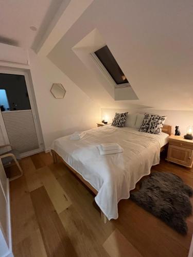 a bedroom with a large white bed and a window at Green-Point Podlasie in Drohiczyn nad Bugiem