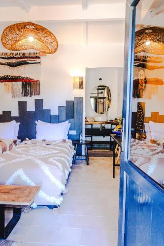a bedroom with a bed and a mirror at Dakhla Attitude in Dakhla