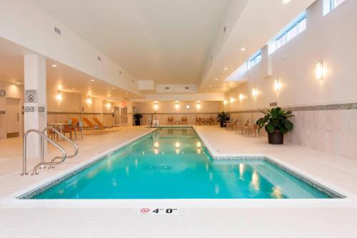 a pool in a building with a swimming pool at Courtyard Peoria Downtown in Peoria