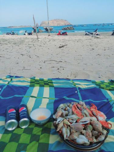 a plate of food on a table on the beach at Biển homestay in Phan Rang