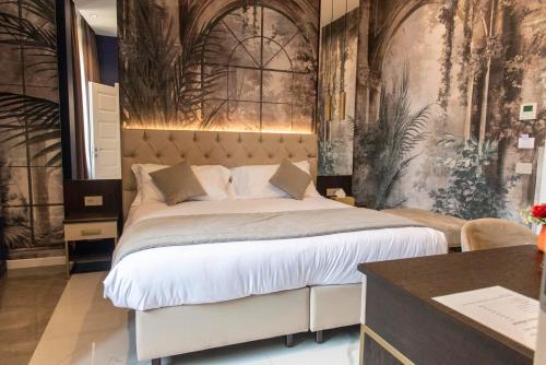 a bedroom with a large bed with a wall mural at Adelaide Suite Dreams in Rome