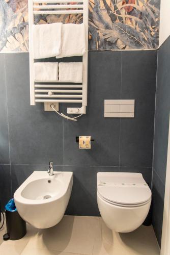a bathroom with a white toilet and a sink at Adelaide Suite Dreams in Rome
