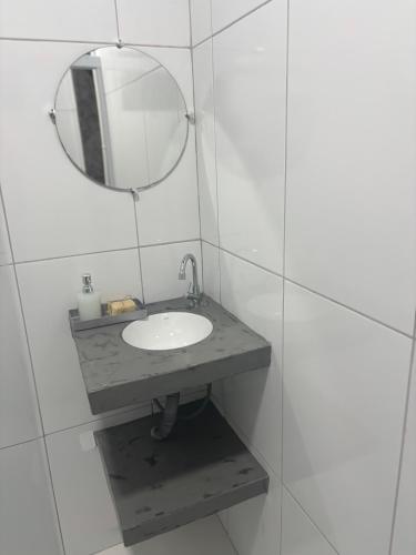 a bathroom with a sink and a mirror at Pousada Água Salgada in Ilha de Boipeba