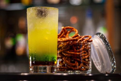 a drink sitting on a table next to a pile of pretzels at Courtyard Winston-Salem Downtown in Winston-Salem