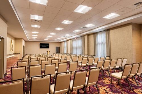 an empty room with chairs and a podium in it at Courtyard Winston-Salem Downtown in Winston-Salem