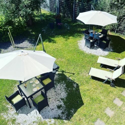 a patio with an umbrella and a table and chairs at Park-Hotel Leimen in Leimen
